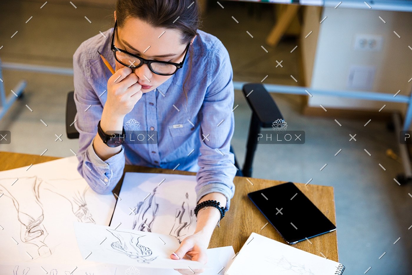 pensive-woman-fashion-designer-sitting-and-PHGZYEM